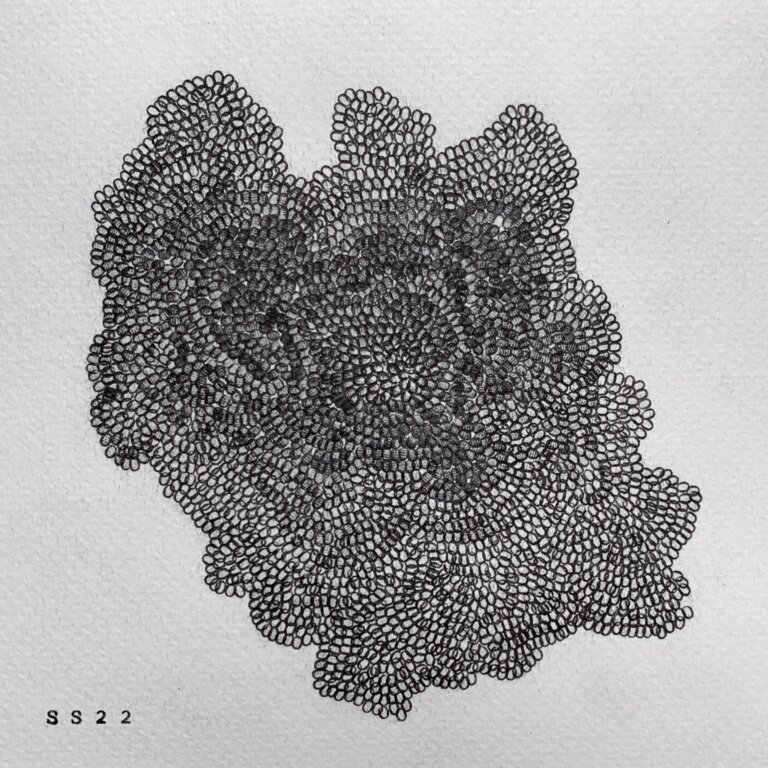 a piece made using a typewriter and little circles all connecting together that resembles a link and this piece is one large shape of the mini circles all grouped together