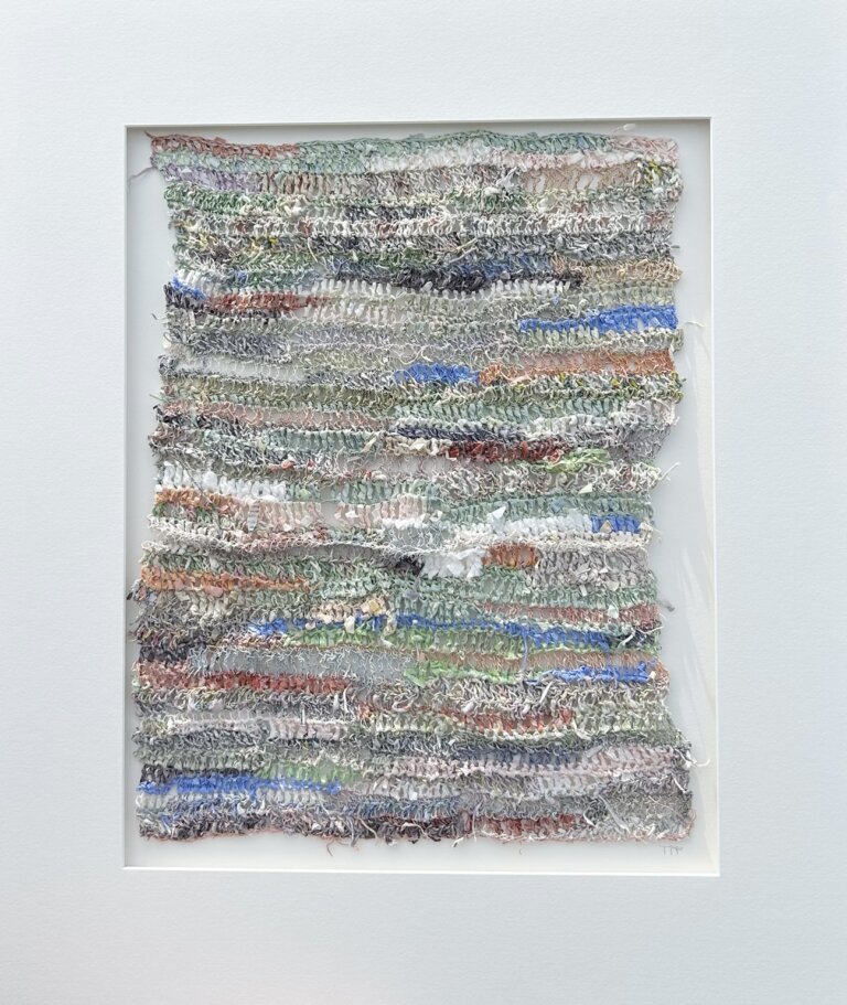 abstract textural piece made of spun painted paper in hues of of pinks, greens and blues primarily, looks like frayed sweater