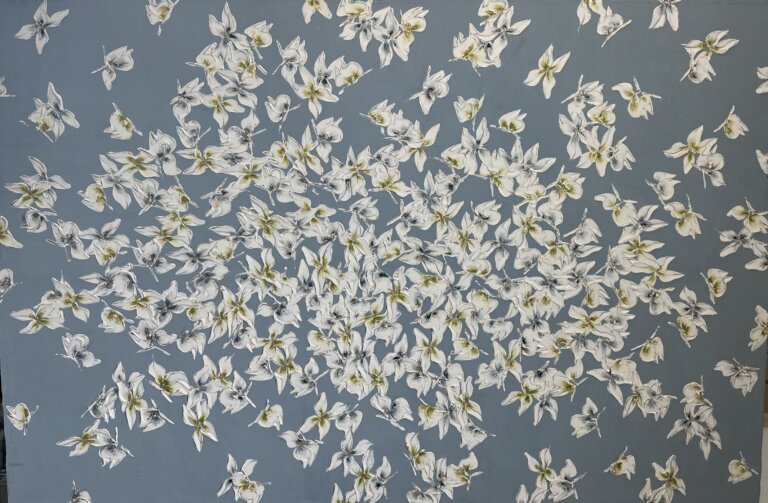 a mixed media piece on canvas of white petal-like butterflies with green and blue centers scattered on a slate gray blue background