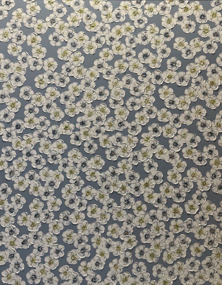 a mixed media piece on canvas of white flowers with blue and green centers scattered on a slate gray background