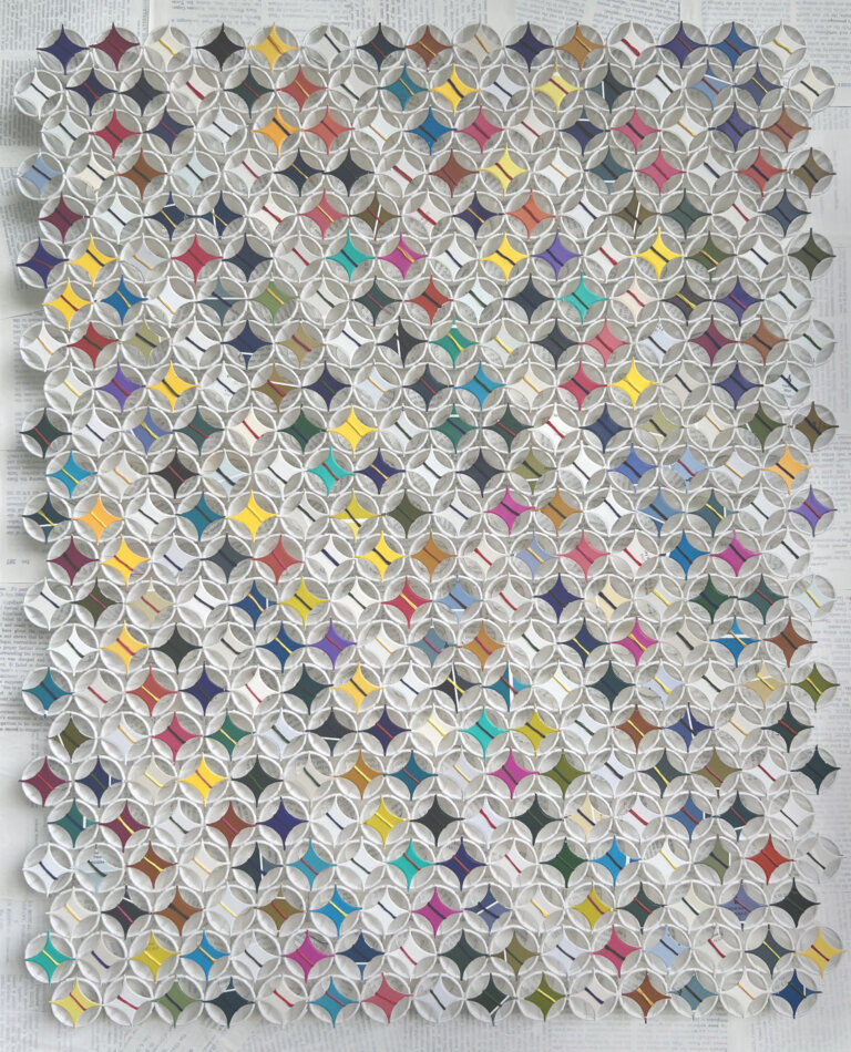 an abstract sculptural art piece with small white paper cups arranged in 23 horizontal rows of 15 or 16, alternating. the rows of cups each have a white four pointed star on top wrapped in colorful string in shaded of red, lemon yellow, cobalt, coral, orange, and gold. some rows have dark red, cherry red, teal, aqua, lavender, pale pink, magenta, or lilac four pointed stars on top each wrapped with string as well. the background is made up of pages from books covered in a thin layer of white paint