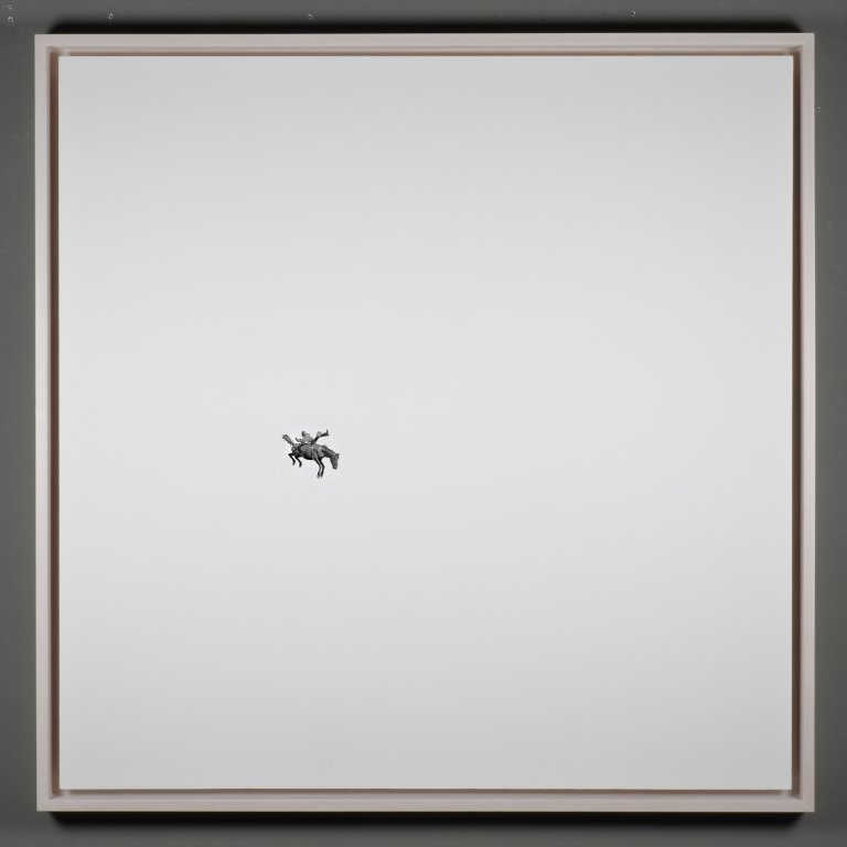 a highly detailed illustration of a rider on a bucking horse in motion drawn painstakingly in graphite in the middle left of a large white panel board