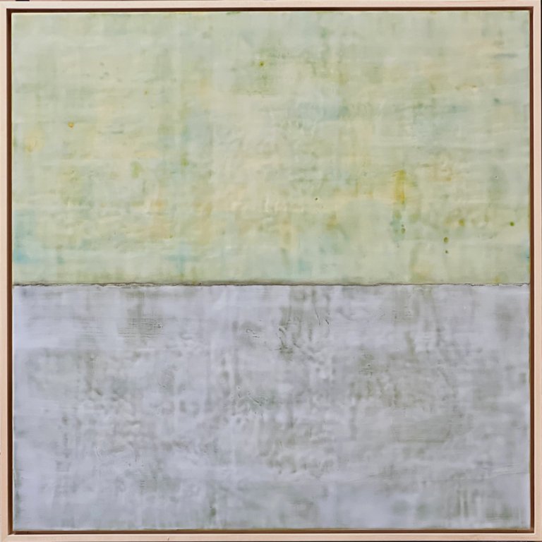 an abstract encaustic piece consisting of two color blocks. the top is a pale yellow with deep teal and olive green peaking through. the bottom section is pale lilac with a slight tinge of taupe. this piece has a feeling that reflects the way one might feel after coming face to face with a difficult, yet just, decision.