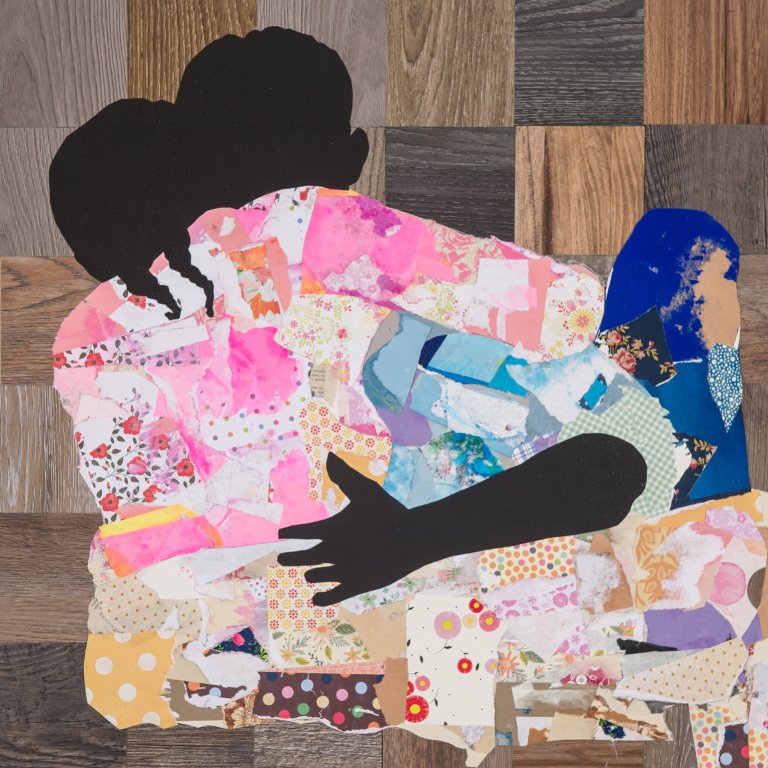an abstract interpretation of a mother and a child hugging. the mother faces forward with the child facing her sitting in her lap. the bodies of the two figures are done in a flat black silhouette, but their clothes are made from brightly colored floral paper collaged together. the colors of the child's garments are pinks and oranges, while the parent wears blues and purples. the background behind the figures is a checkerboard of different woodgrains