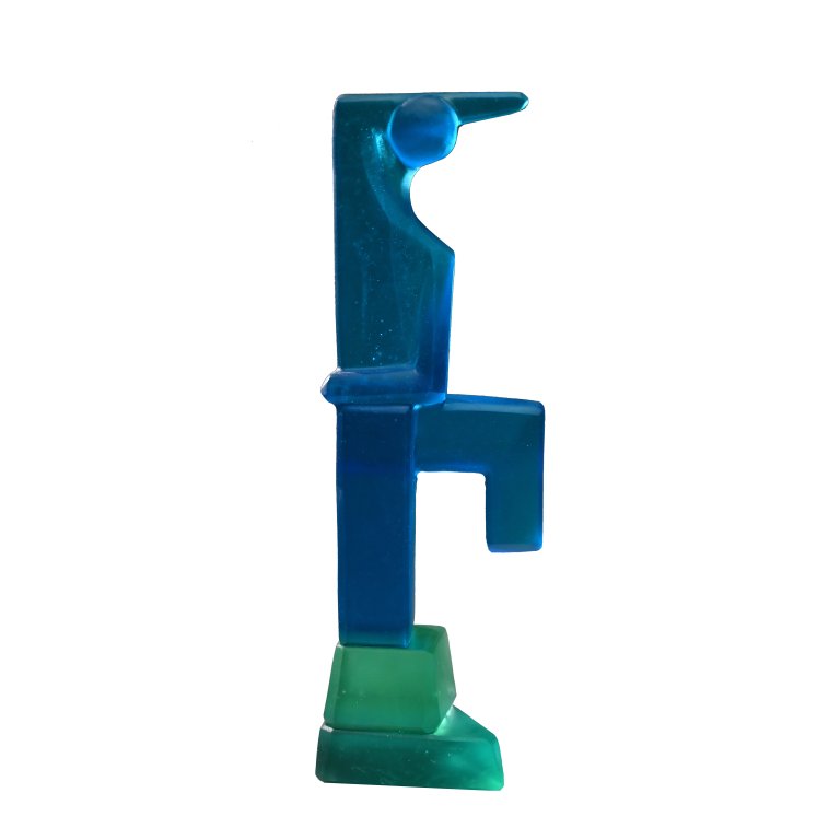a hand cast glass sculpture in two tones. the figure is bright blue and the base is teal. the figure stands with one leg lifted to the side at a right angle with the knee bent and the other leg straight. the arms are both bent; one arm is bent inward across the figure in first position, and the other arm is bent up and over behind the figure's head
