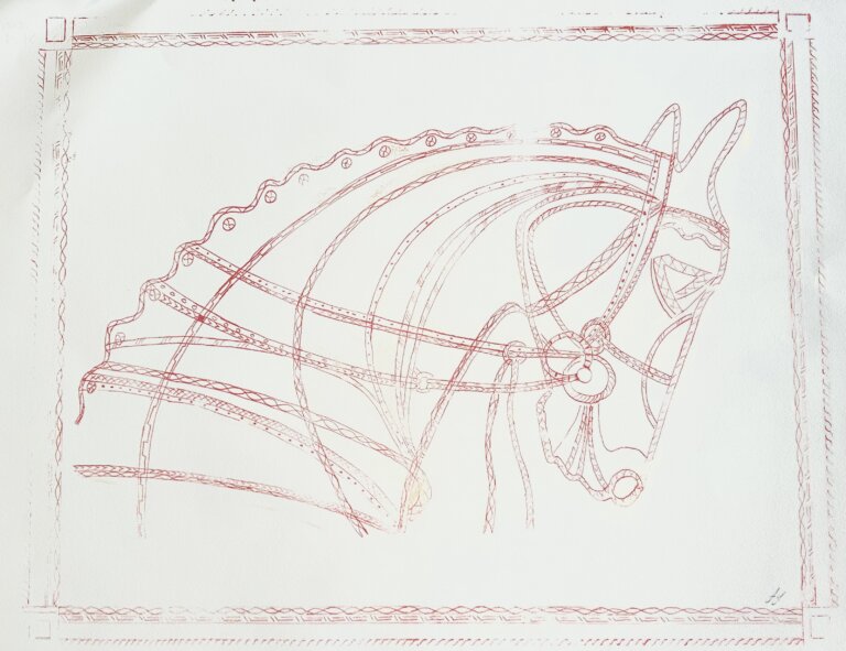 a print of a horse's head in profile. there is a thin border around it in light red. the horse itself is outlined in thin red. he bows his head to the right and has a bridle on. the background is white