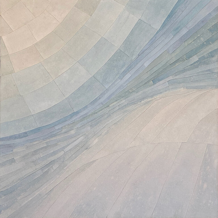 an abstract layered art piece that has a geological feel. the pieces move together in a soft swell. the colors are an ombre of tan, taupe, gray, various blues, and soft stone