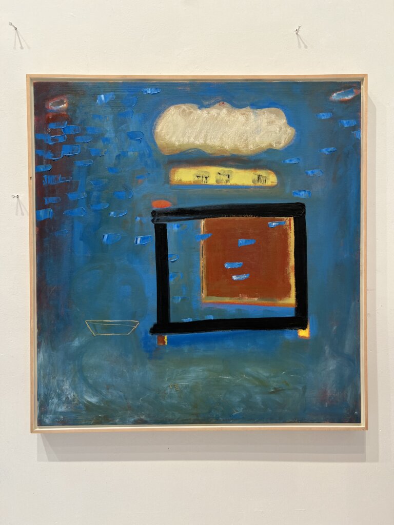 an abstract art piece with a deep turquoise and dark blue background. there is a black rectangle outlined on the piece towards the middle a little off center to the right. inside is a rust colored rectangle with a vague yellow border. above the black box there is a cream colored cloud shape with a yellow bar under it. there are several small horizontal shapes in electric blue scattered across the painting