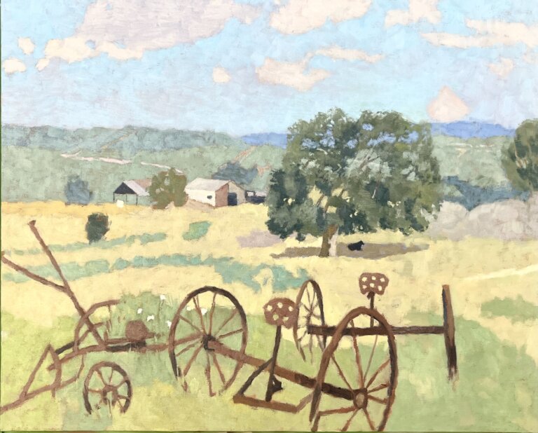 a few rusted farm tools with large wheels rest unattended in a yellow field with a green tree in the center of it. a small black cow rests in the shade under the tree. there is a white and tan farmhouse in the distance at the edge of the field. around the farmhouse are scattered bushes and boulders. there are rolling green and blue hills in the distance. the sky above is pale blue with white clouds