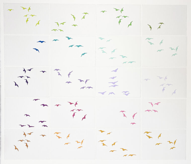 20 panels of paper with cutouts of flying birds. each panel has a different color showing through the cutouts. From green to blue to purple to red to orange.