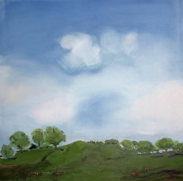 landscape with green, wooded hills and pops of red flowers. The blue sky has white and pink clouds.