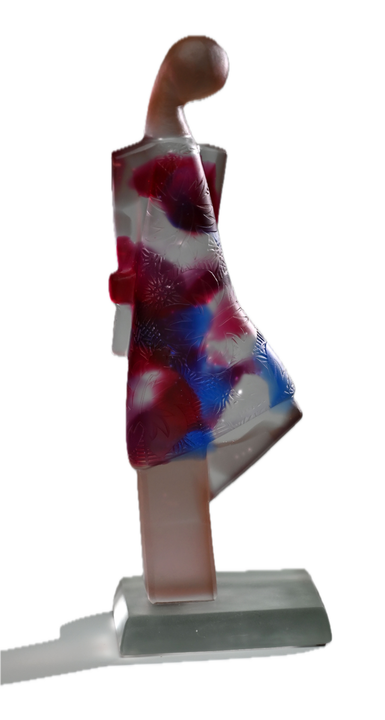 a hand cast clear, red and blue glass interpretation of a woman with a bent leg