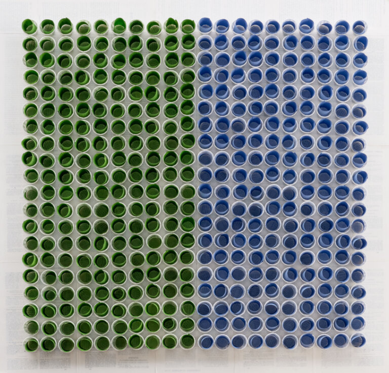 collage of white condiment cups with multi colored strips of paper rolled into the cups, the left side has green papers in the cups and the right side is blue papers in the cups