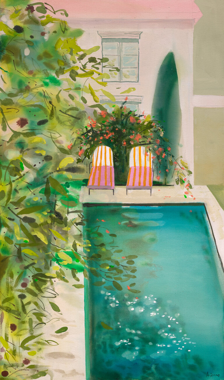 this garden pool scene depicts a turquoise pool filled the foreground with soft, dappled reflections. two pink and orange striped lounge chairs sit side by side behind the pool on the pale stone edge. a tall, dark green cypress and bush with coral blossoms stand against the structure beside a light, sun-washed façade with one simple window. lush greenery and flowering vines spill outward in layered greens aside the pool